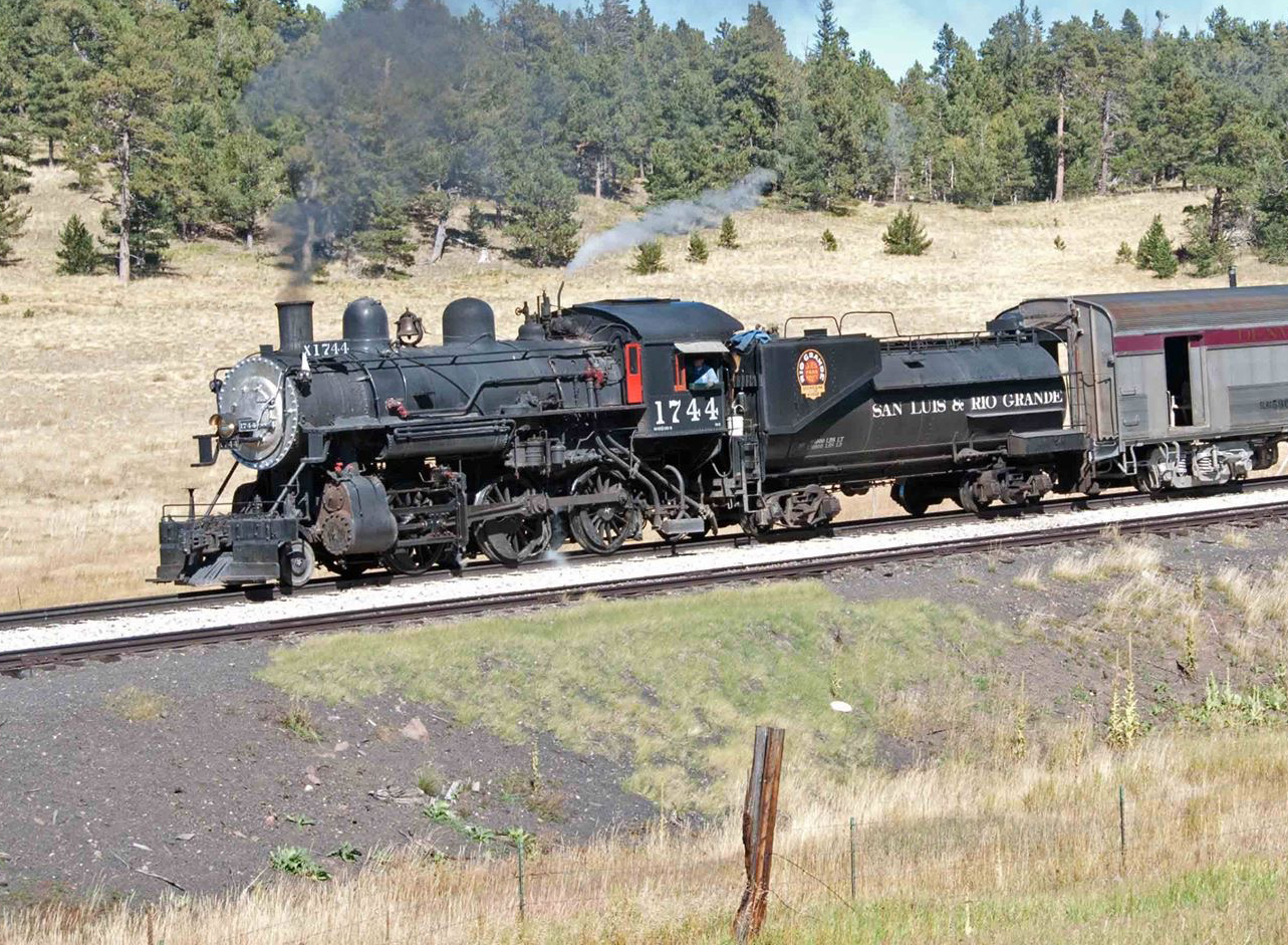 Steam locomotive, Southern Pacific number 1744, rolls along a track wearing the lettering of its previous owner, the San Luis and Rio Grande Railroad. The Niles Canyon Railway purchased the locomotive from them.