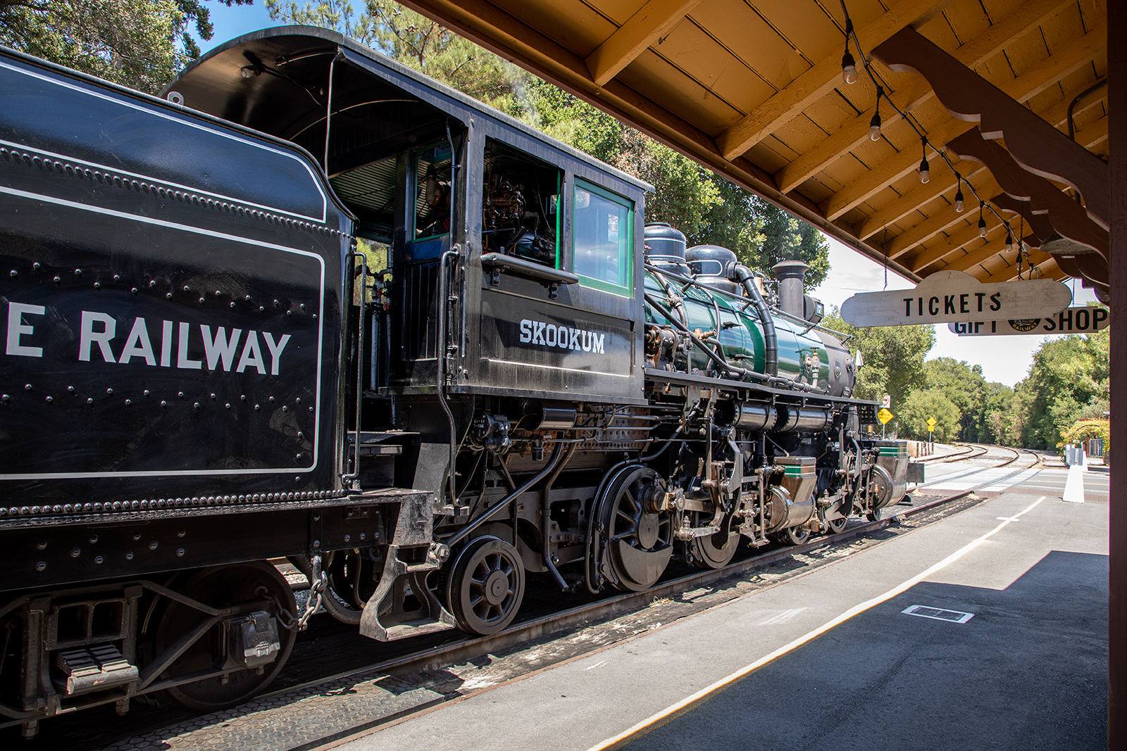A large steam locomotive originally from the Columbia River Belt Line Railway sits in front of the museum's train station.